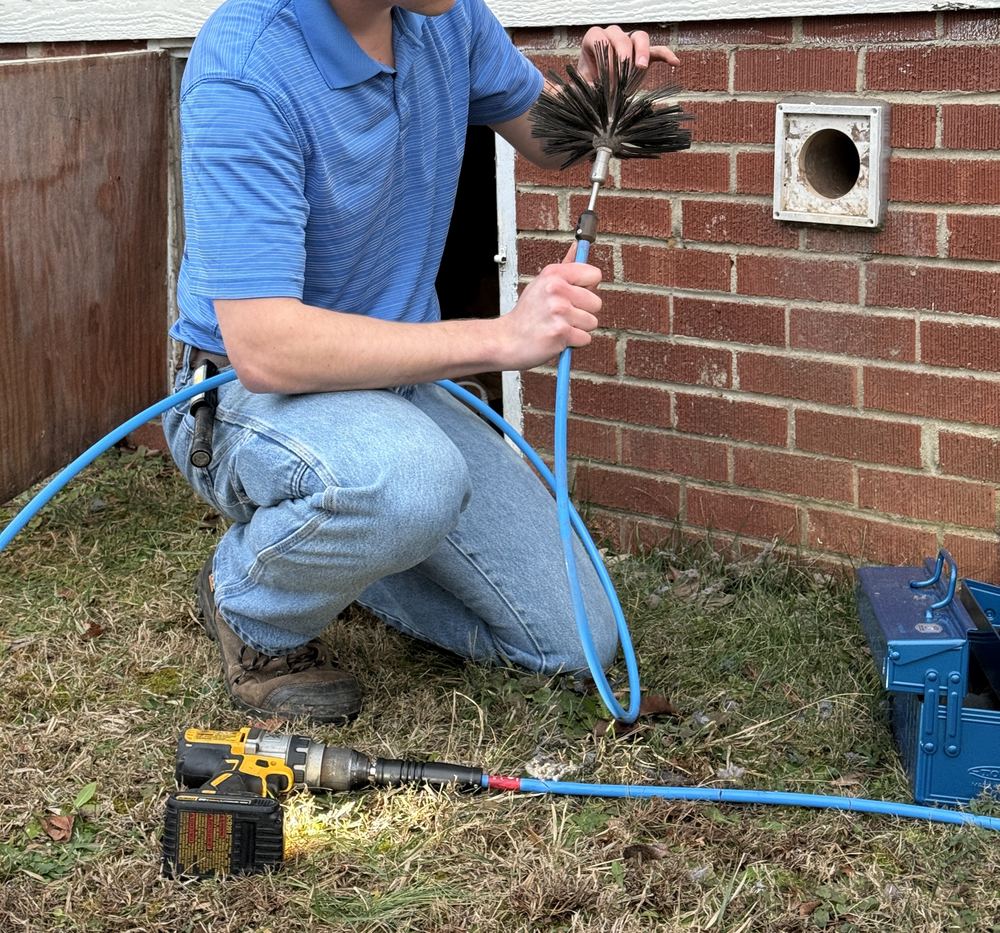 Lintlock technician with rotary vent cleaning brush and equipment