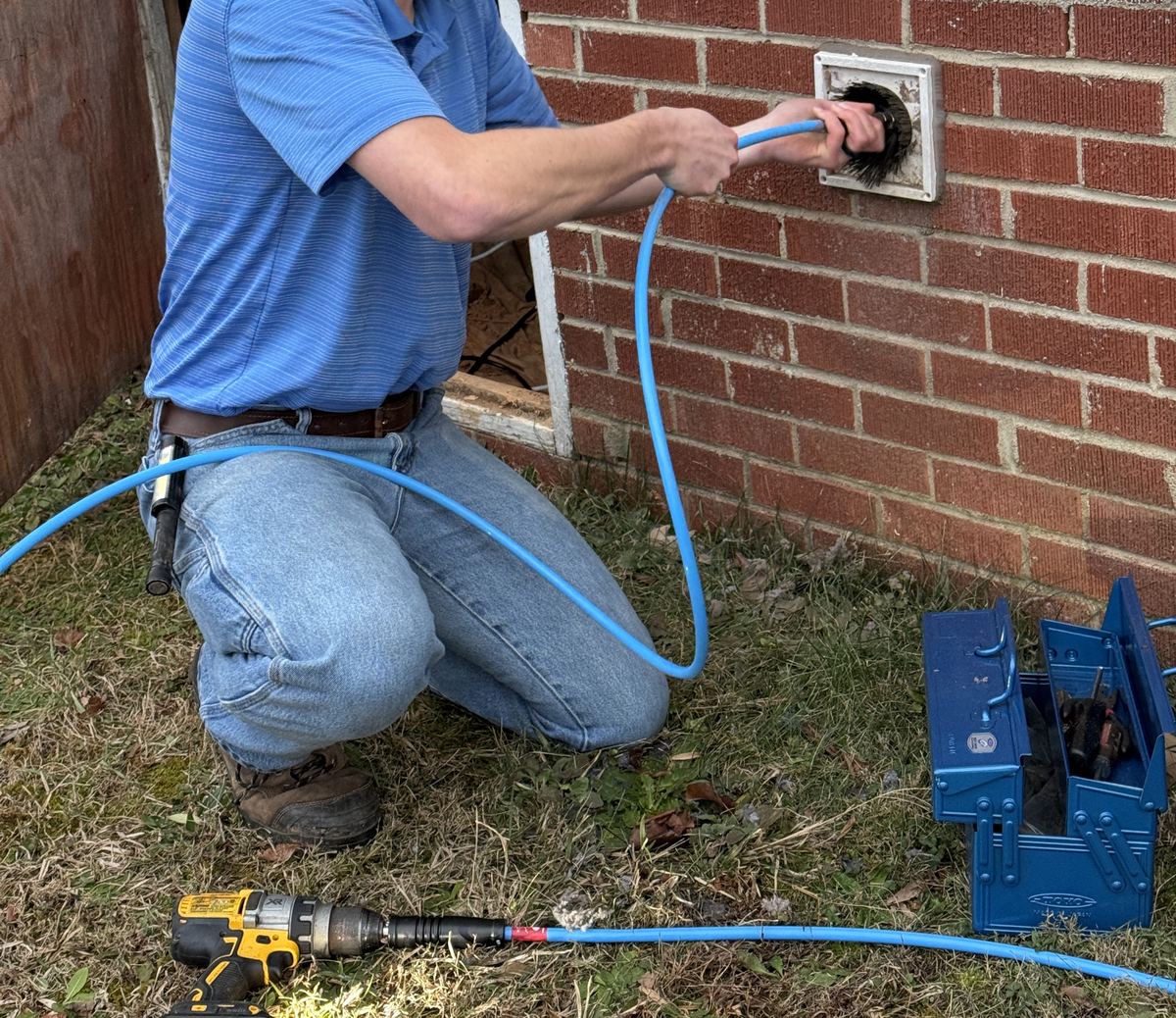 Lintlock technician cleaning a dryer vent with a rotary brush